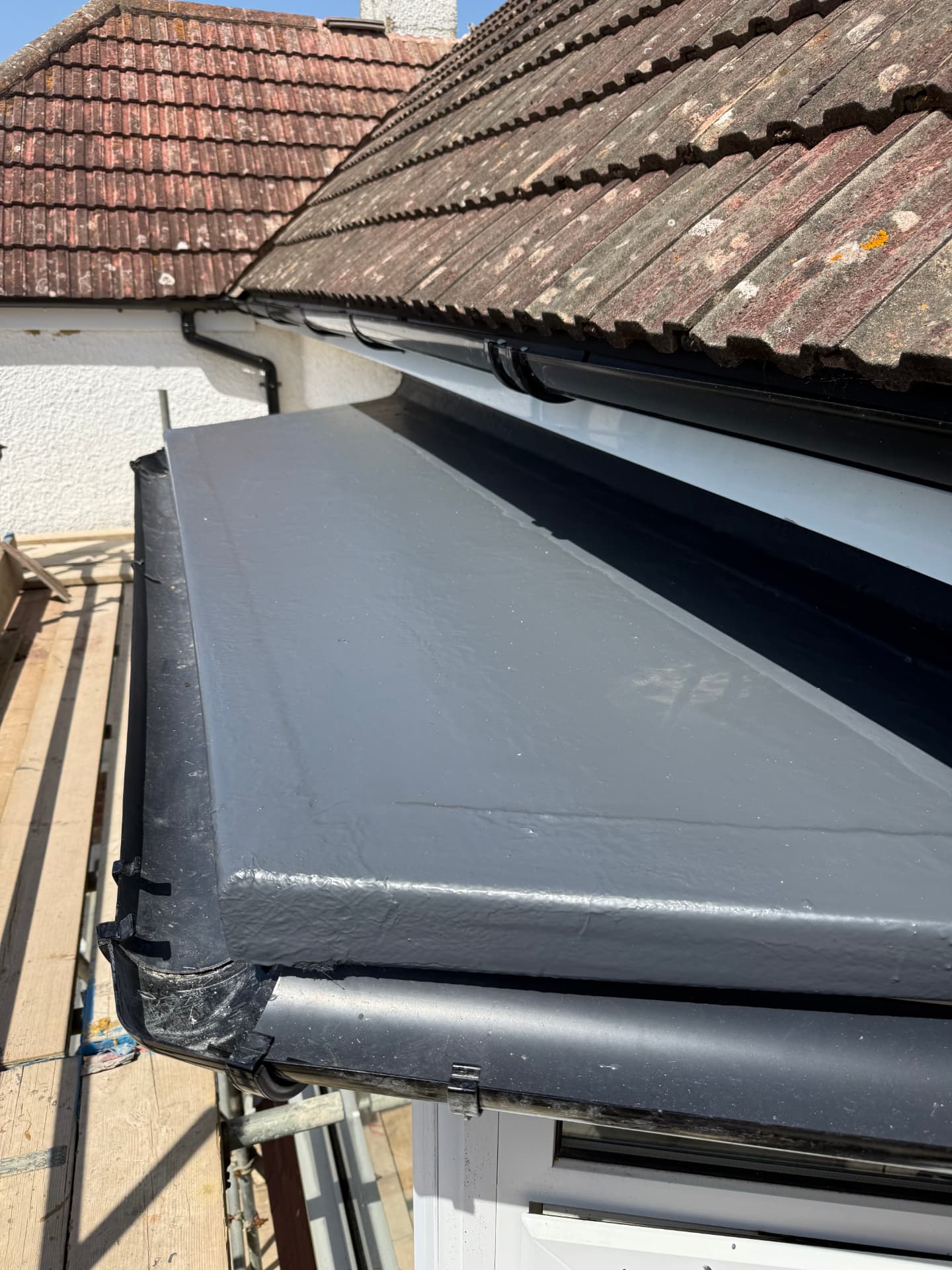 Grey GRP flat roof with new fascia and guttering